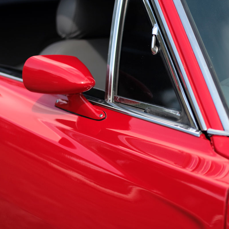 closeup of red paint on a vintage car
